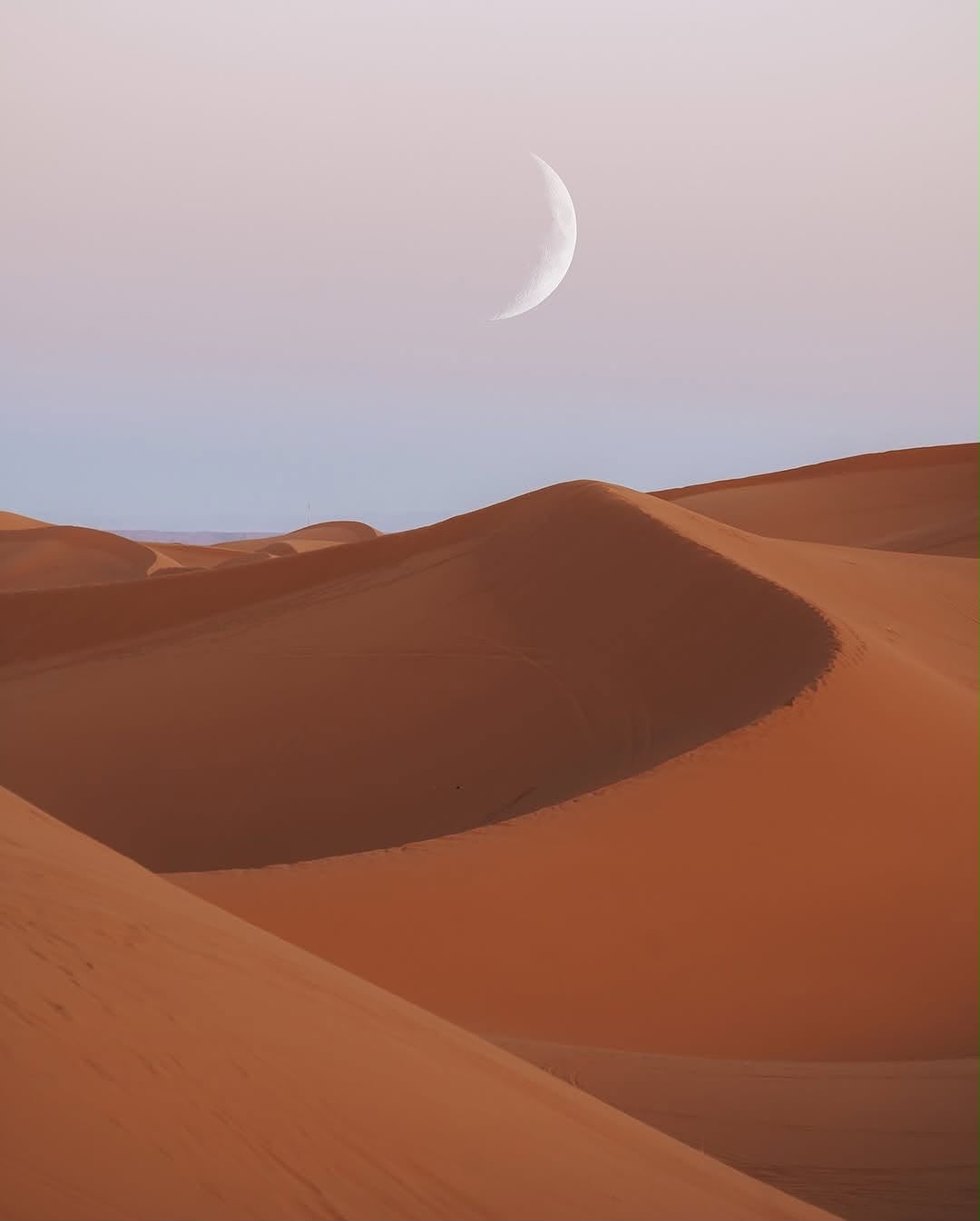 Fire & Drums Night Crescent moon above the Erg Chebbi sand dunes at dusk – Merzouga