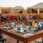 Moroccan tea and breakfast table set outside a desert camp – Merzouga, Morocco