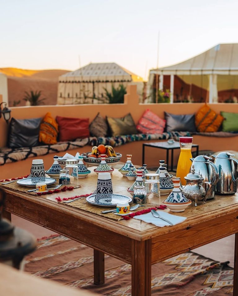Private Transport in Morocco Moroccan tea and breakfast table set outside a desert camp – Merzouga