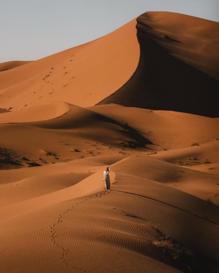 Guided Walking Tour Walker on a high dune ridge in the Sahara – Merzouga