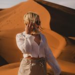 Woman in a white shirt standing in the Merzouga dunes – Merzouga, Morocco