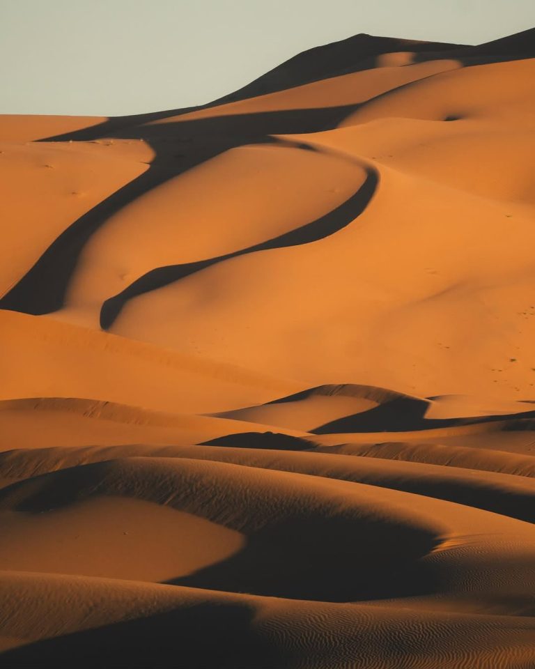 Rolling sand dunes of the Sahara at golden hour – Merzouga