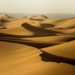 Golden dunes stretching to the horizon in Erg Chebbi – Merzouga, Morocco