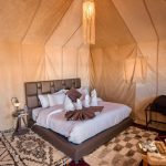 Luxury desert camp tent bedroom with a double bed – Merzouga, Morocco