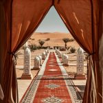 Entrance of a desert camp with red carpet and lanterns – Merzouga, Morocco
