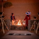 Berber staff at the fire pit of a desert camp at night – Merzouga, Morocco