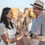Couple exchanging rings at a desert wedding with camels – Merzouga, Morocco