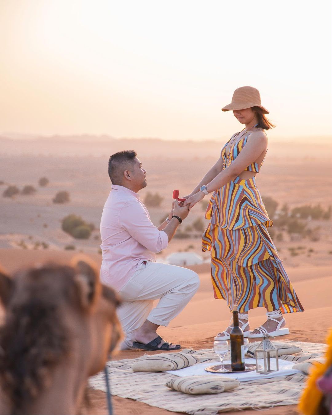 Marriage proposal on a dune at sunset