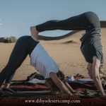 Yoga downward-dog pose on the sand in Merzouga – Merzouga, Morocco