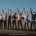 Yoga retreat group celebrating in the dunes – Merzouga, Morocco