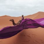 Purple scarf flying in the wind on a Sahara dune – Merzouga, Morocco