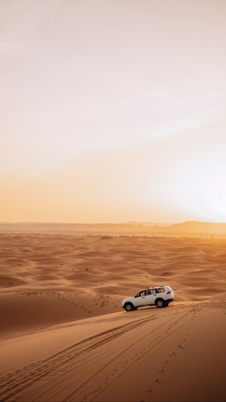 Private Transport in Morocco 4x4 vehicle in the Merzouga dunes at sunset – Merzouga