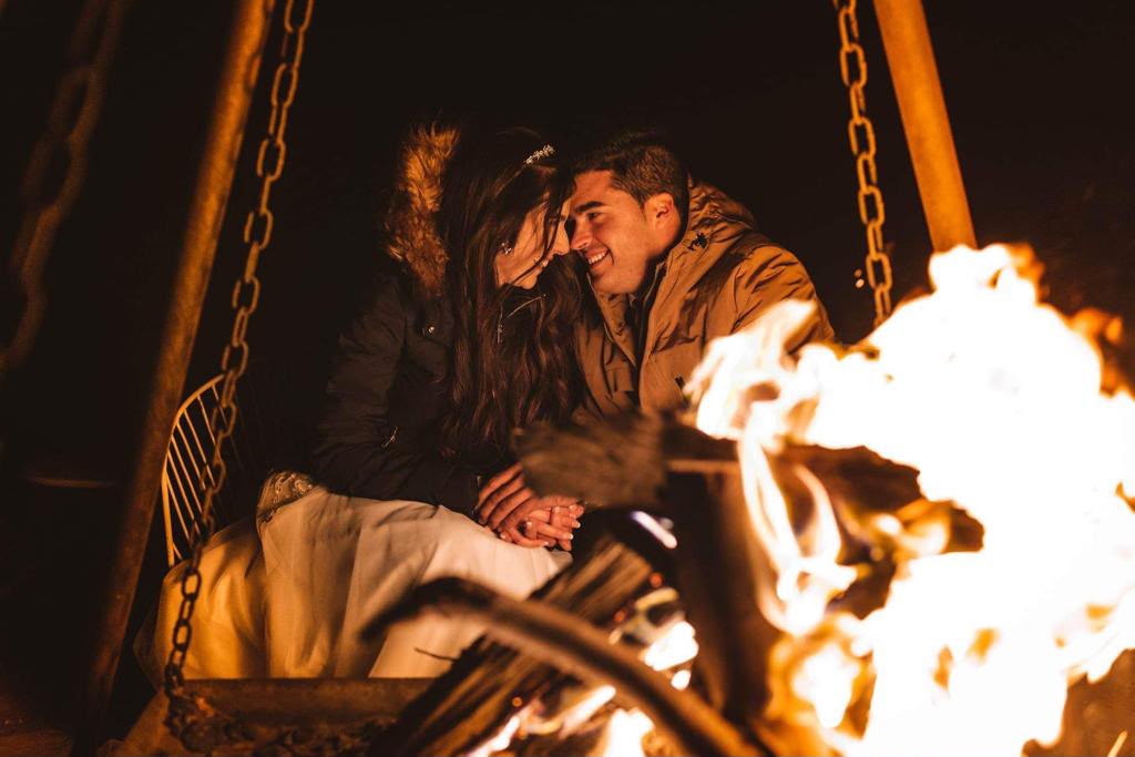 Fire & Drums Night Couple sitting by the campfire on a desert night – Merzouga