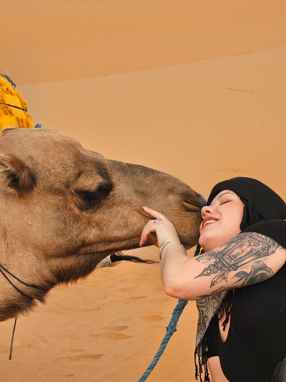 Camel Ride Woman hugging a camel in the desert – Merzouga