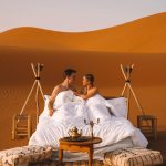 Couple enjoying a romantic setup on the dunes – Merzouga, Morocco