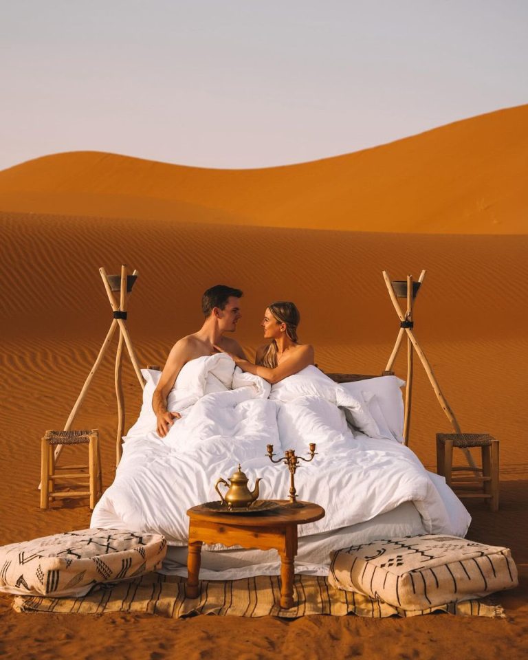 Couple enjoying a romantic setup on the dunes – Merzouga