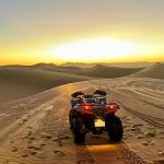 Buggy driving through the dunes at sunset – Merzouga, Morocco