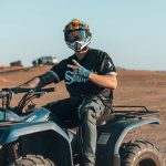 Smiling rider on a quad bike in the Merzouga desert – Merzouga, Morocco