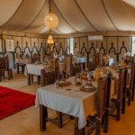 Large restaurant tent of a desert camp with set tables – Merzouga, Morocco